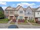 Charming townhome exterior with stone accents and a well-manicured front yard at 7822 Allscott Way, Raleigh, NC 27612