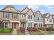 Charming townhome exterior with stone accents and a well-manicured front yard at 7822 Allscott Way, Raleigh, NC 27612
