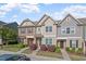 Charming townhome exterior with stone accents and a well-manicured front yard at 7822 Allscott Way, Raleigh, NC 27612