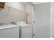 Laundry room with washer, dryer, and shelving for storage at 7822 Allscott Way, Raleigh, NC 27612
