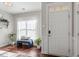 Bright and airy entryway with a comfortable bench and stylish decor at 7822 Allscott Way, Raleigh, NC 27612