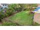 Overhead view of large backyard, grass, wood fence, and wood deck at 801 Silver Leaf Pl, Raleigh, NC 27609