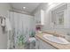 Bathroom featuring a vanity sink, tiled floors, and a shower with a leafy curtain at 801 Silver Leaf Pl, Raleigh, NC 27609
