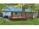Back exterior featuring back deck, brick, metal roof and yard at 801 Silver Leaf Pl, Raleigh, NC 27609