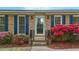 Close-up of the front door, with glass, sidelights, blue shutters and vibrant flowers at 801 Silver Leaf Pl, Raleigh, NC 27609