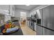 Bright kitchen featuring white cabinets, stainless appliances, tile backsplash, and breakfast nook view at 801 Silver Leaf Pl, Raleigh, NC 27609