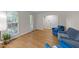 Bright living room featuring hardwood floors, large windows, and comfortable blue seating at 801 Silver Leaf Pl, Raleigh, NC 27609