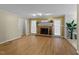 Cozy living room with a brick fireplace, hardwood floors, and lots of natural light at 801 Silver Leaf Pl, Raleigh, NC 27609