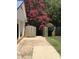 Wooden fence gate near house and path with bright pink tree at 801 Silver Leaf Pl, Raleigh, NC 27609
