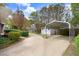 Expansive backyard features a covered carport, storage shed, and mature trees, creating an inviting outdoor space at 806 S Second St, Smithfield, NC 27577