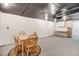 Expansive basement showcasing a dining set, white-painted brick, and a dark ceiling at 806 S Second St, Smithfield, NC 27577