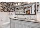 Elegant bathroom featuring a double sink vanity, modern fixtures, and stylish wallpaper at 806 S Second St, Smithfield, NC 27577