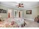 Bedroom featuring a ceiling fan, natural light, and multiple closets and entryways at 806 S Second St, Smithfield, NC 27577