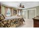 Bedroom with neutral carpet, ceiling fan, large windows, and closet storage at 806 S Second St, Smithfield, NC 27577