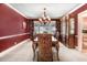 Formal dining room with red accent wall, chandelier, and vintage hutch at 806 S Second St, Smithfield, NC 27577
