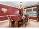 Cozy dining room with a large wooden table and patterned upholstered chairs under a chandelier at 806 S Second St, Smithfield, NC 27577