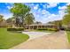 Well-maintained brick home with a circular driveway and lush landscaping provides a welcoming curb appeal at 806 S Second St, Smithfield, NC 27577
