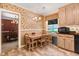 Bright eat-in kitchen with wood cabinets, modern appliances, and a charming floral wallpaper at 806 S Second St, Smithfield, NC 27577