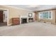 Spacious living room featuring a decorative fireplace, neutral carpet, and a bright window at 806 S Second St, Smithfield, NC 27577