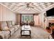 Inviting living room with comfortable seating, a patterned ceiling, and a brick fireplace at 806 S Second St, Smithfield, NC 27577