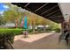 Brick patio with outdoor seating under a shade features lush landscaping and a serene atmosphere at 806 S Second St, Smithfield, NC 27577