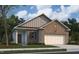 Charming single-story brick home with an attached garage and landscaped front yard at 833 Kenyon Spring Dr, Zebulon, NC 27597