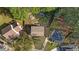 Expansive aerial view of a quaint house with a fire pit in the backyard, surrounded by lush greenery and mature trees at 8333 Bellingham Cir, Raleigh, NC 27615