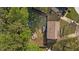 Aerial view of property showing the backyard with patio, garden, shed, seating and mature trees at 8333 Bellingham Cir, Raleigh, NC 27615