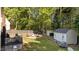 Spacious backyard featuring a shed, patio, garden, seating, and a wooded surround at 8333 Bellingham Cir, Raleigh, NC 27615