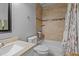 Cozy bathroom featuring a tiled shower and tub, vanity, toilet, and decorative accents at 8333 Bellingham Cir, Raleigh, NC 27615
