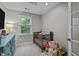 Bedroom featuring a crib, dresser, window, and decorative touches at 8333 Bellingham Cir, Raleigh, NC 27615