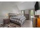 Bright bedroom with a vaulted ceiling, neutral walls, a large bed, hardwood floors, and natural light from two windows at 8333 Bellingham Cir, Raleigh, NC 27615