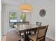 Inviting dining area with french doors, a view of the outdoors, and a stylish light fixture, with seating for five at 8333 Bellingham Cir, Raleigh, NC 27615