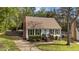 Charming home with well-kept lawn, shrubbery, brick chimney, and inviting front steps at 8333 Bellingham Cir, Raleigh, NC 27615