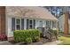 Close-up of a home's inviting front entrance with manicured landscaping and stylish accents at 8333 Bellingham Cir, Raleigh, NC 27615