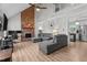 Spacious living room with a vaulted ceiling, brick fireplace, and an open view to the kitchen at 8333 Bellingham Cir, Raleigh, NC 27615