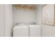 Functional laundry room with modern washer and dryer, shelving, and wall art at 87 Glencoe Ln, Zebulon, NC 27597
