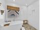 Bright bathroom featuring soaking tub and shower, white subway tile, and large window with woven shade at 8721 Attingham Dr, Raleigh, NC 27615