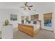 Bright bedroom featuring vaulted ceiling with ceiling fan and large windows with woven shades at 8721 Attingham Dr, Raleigh, NC 27615