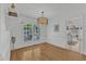 Bright dining room with hardwood floors, modern light fixture, and ample natural light at 8721 Attingham Dr, Raleigh, NC 27615