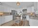 Modern kitchen with stainless steel appliances, tile backsplash, and white cabinets at 8721 Attingham Dr, Raleigh, NC 27615
