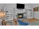 Cozy living room with a fireplace, built-in bookshelves, hardwood floors, and plenty of seating at 8721 Attingham Dr, Raleigh, NC 27615