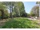 Picturesque backyard with lush lawn, mature trees, and patio perfect for Gathering enjoyment at 904 Coral Bell Dr, Wake Forest, NC 27587