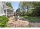 Landscaped backyard with a patio, seating, screened-in porch, and play set at 904 Coral Bell Dr, Wake Forest, NC 27587