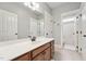 Bathroom featuring a double sink vanity with wood cabinets and neutral colored tile flooring at 904 Coral Bell Dr, Wake Forest, NC 27587