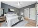 Bedroom featuring hardwood floors, gray walls, ceiling fan, and ensuite bathroom at 904 Coral Bell Dr, Wake Forest, NC 27587