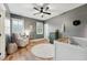 This Bedroom has a white crib, rocker, light wood floors and a ceiling fan at 904 Coral Bell Dr, Wake Forest, NC 27587