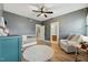 Bedroom room features a wooden floor, ceiling fan, rocker, and white crib at 904 Coral Bell Dr, Wake Forest, NC 27587