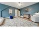 This bedroom is large and features a modern rug, hardwood floors, and blue accent walls at 904 Coral Bell Dr, Wake Forest, NC 27587