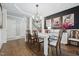Elegant dining room with hardwood floors, modern lighting and stylish decor that creates a cozy and sophisticated ambiance at 904 Coral Bell Dr, Wake Forest, NC 27587